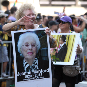 Suzanne Manford Swan marching with a photo of her mother